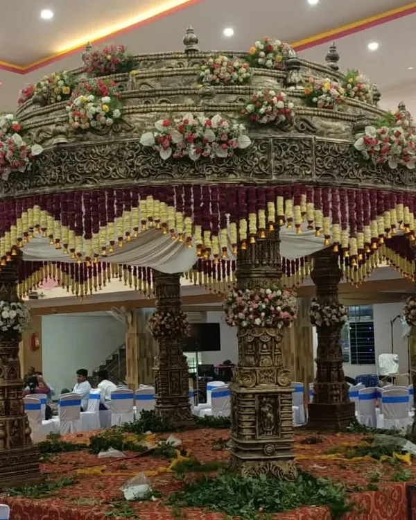 I specialize in creating magnificent, traditional mandaps that become the heart of the wedding ceremony. This is an example of an intricate South Indian mandap, showcasing detailed craftsmanship and floral decoration for a grand celebration.