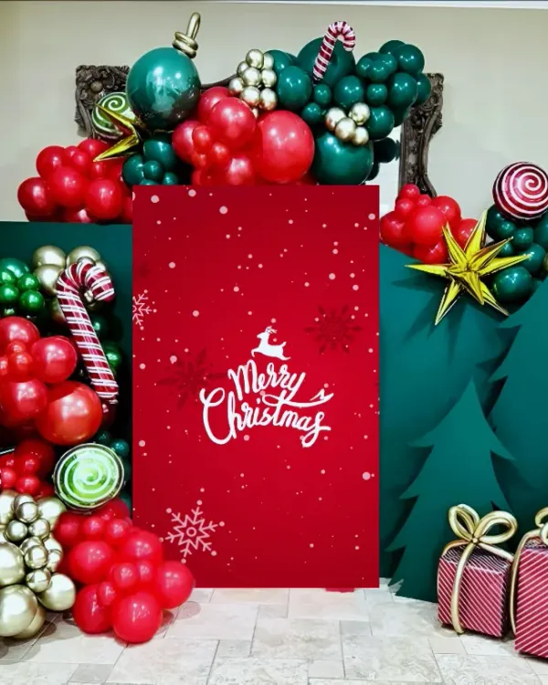 Photo booths are a must have for any celebration. I designed this whimsical Christmas photo corner using a combination of balloon art to create candy canes and ornaments, custom-cut trees, and a bold red backdrop. It’s a fun, festive, and perfectly Instagrammable addition to any corporate holiday party.
