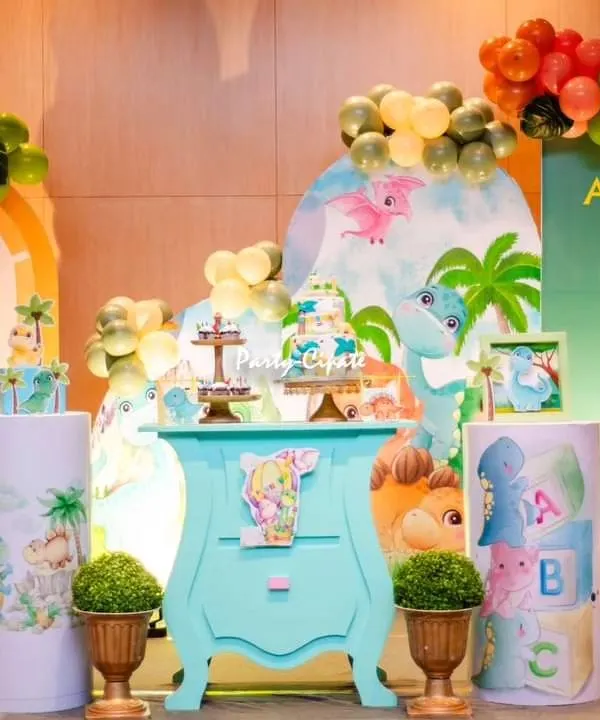 A full view of the 'Little Dino' theme I created for Avyaan. The setup featured a colorful balloon arch, cute dinosaur cutouts, and a custom-painted dresser for the cake table.