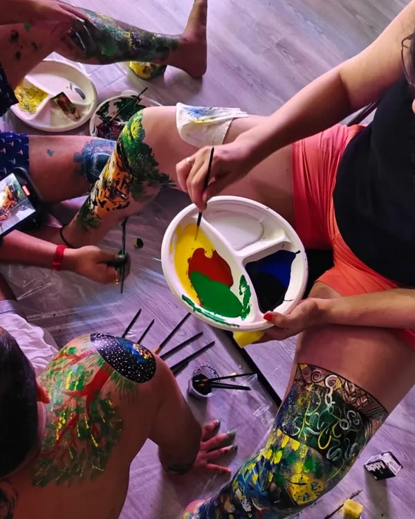 The beautiful, messy result of a body painting workshop. Participants use each other as canvases, exploring creativity and connection in a very personal and tactile way. It is an experience of pure, uninhibited expression.