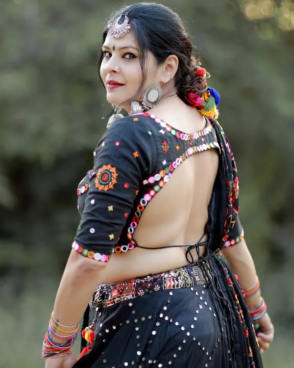 This is the kind of statement piece I love creating for dandiya nights. I designed this custom black lehenga for Navratri, focusing on intricate mirror work and a bold, open-back blouse that commands attention.