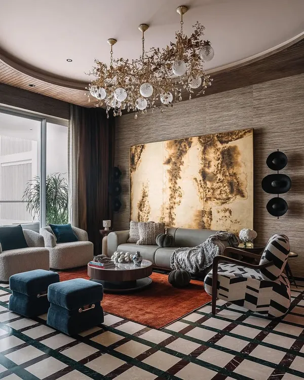 We believe a living space should be a composition of texture, art, and personal narrative. Here, natural grasscloth wallpaper provides a warm, tactile backdrop for sculptural seating, bold artwork, and curated objects, creating a room that is both sophisticated and deeply inviting.