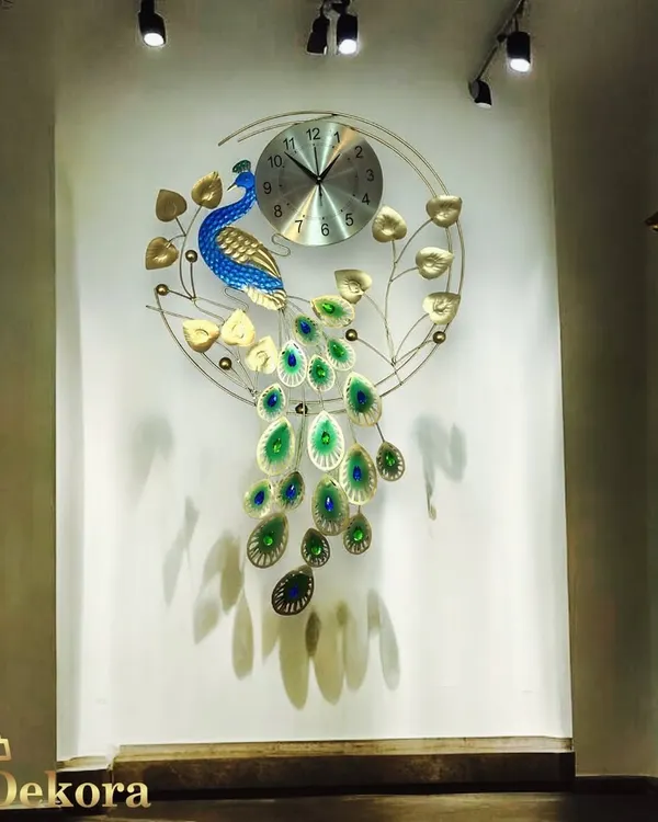 This handcrafted metal peacock clock is one of our signature pieces, designed to be a stunning work of art for your living room or entryway wall.