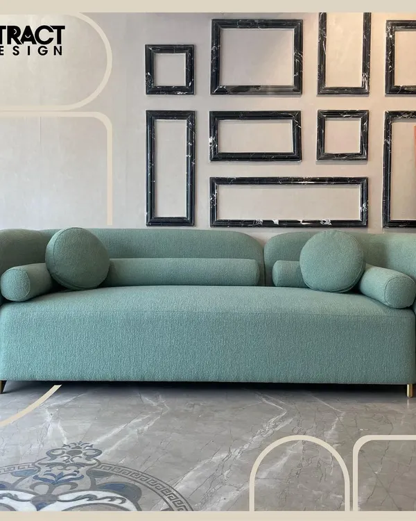 Our "Cloud" sofa, shown here in a full view, features a dreamy, rounded form and is upholstered in a lush moss green bouclé fabric. It's a perfect centerpiece that combines contemporary design with a serene, inviting feel.