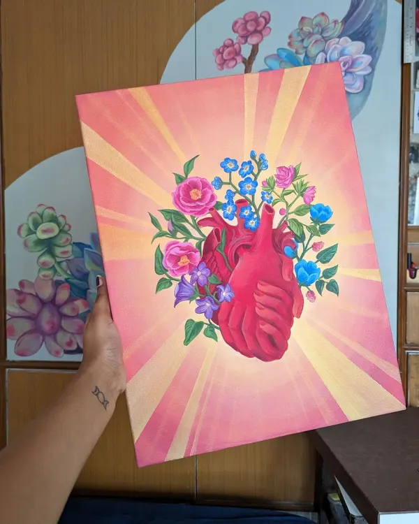 A finished canvas painting featuring a floral anatomical heart, glowing with warm light. This piece combines my love for botanical elements with a surreal concept, creating a powerful and beautiful image. These paintings are available as custom commissions.