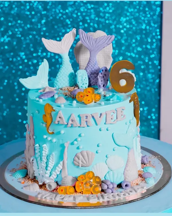 An incredible mermaid-themed cake, complete with tails, seahorses, and shells. We capture the artistry of your custom cake.