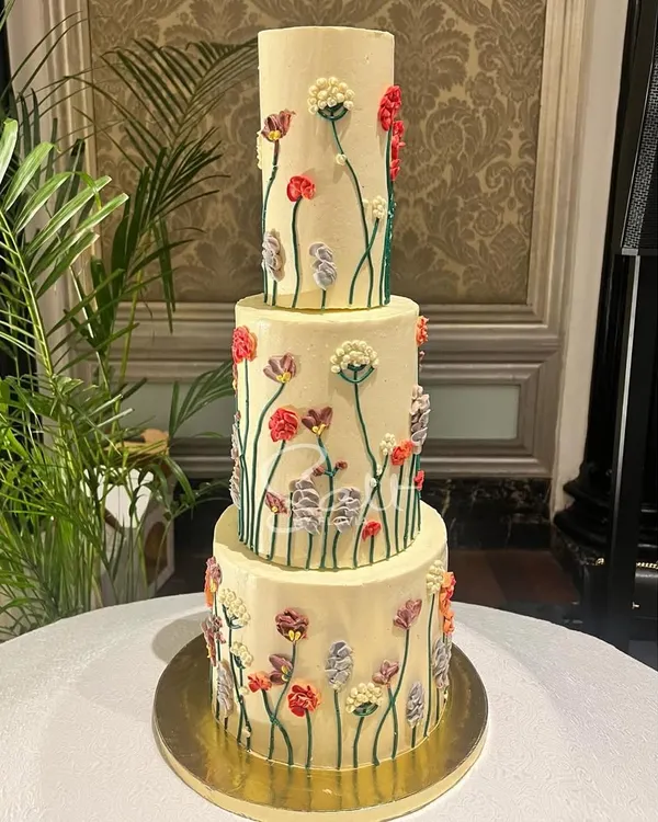 This three-tiered beauty is a custom chocolate fudge cake, hand-piped with a field of wildflowers. It was the centerpiece for a beautiful wedding, and I love how the delicate buttercream flowers came to life. This is the kind of challenge that gets me excited to bake.