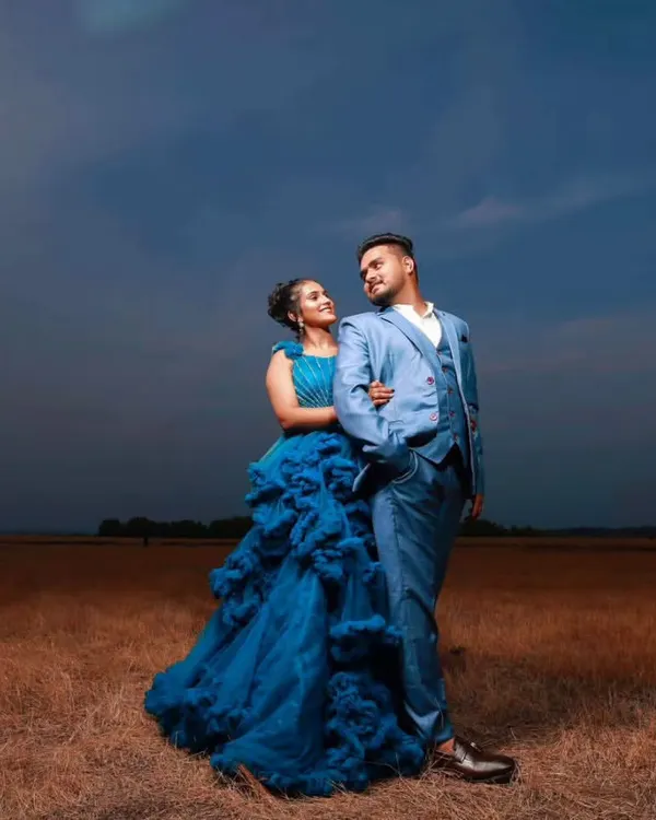 A dramatic, moody shot from a pre-wedding session. I styled the groom in a sharp light blue three-piece suit to perfectly match the bride's ruffled gown.