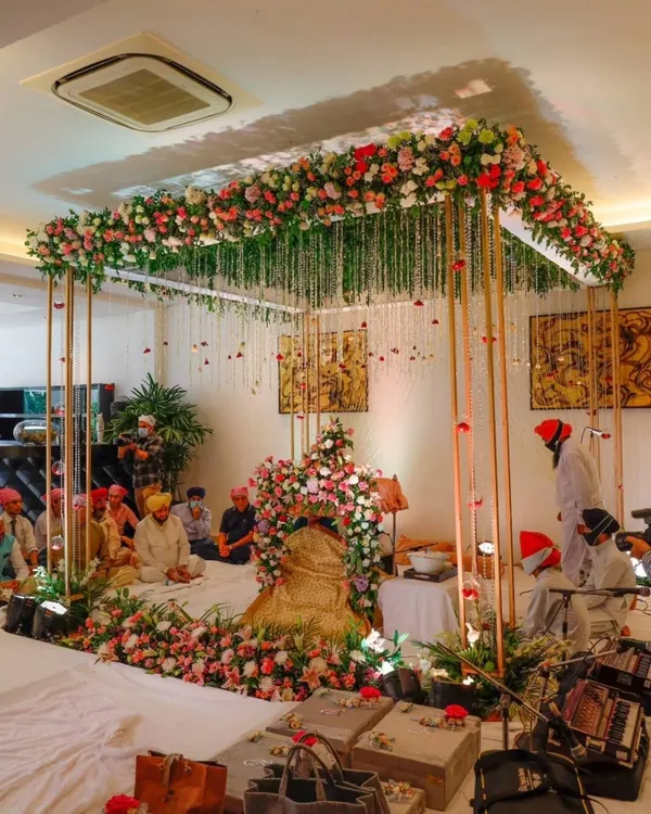 A beautiful floral canopy for a Sukhmani Sahib Path ceremony held at a private residence. The setup is rich with fresh flowers, creating a divine and peaceful atmosphere for the sacred prayers.