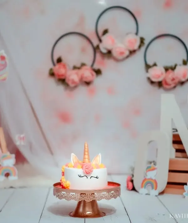 The full setup for our magical unicorn-themed first birthday shoot. With a teepee, floral hoops, and the "ONE" letters, this backdrop is ready for a celebration.