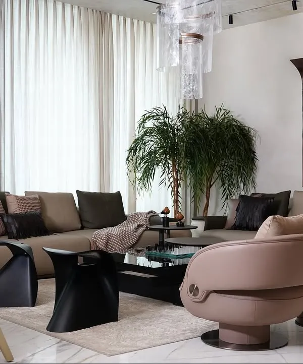 We designed this open-plan living and dining space at The Amaryllis to feel both sophisticated and warmly inviting. By pairing earthy tones with tactile materials like exposed brick and soft, light-filtering curtains, we created a calm and airy atmosphere perfect for daily living and elegant entertaining.