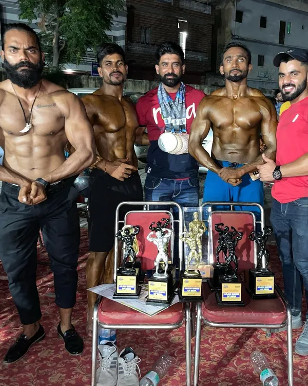 The whole team celebrating after a successful competition. Multiple students, multiple trophies. This is the result of our shared commitment to excellence in natural bodybuilding.