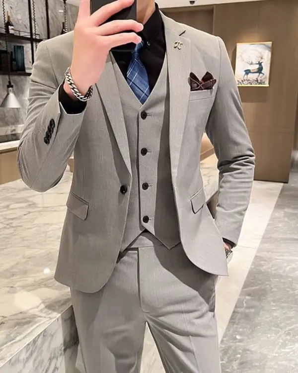 A customer looking sharp in a classic light grey three-piece suit. This is a versatile outfit that works perfectly for a formal day event or a business meeting.
