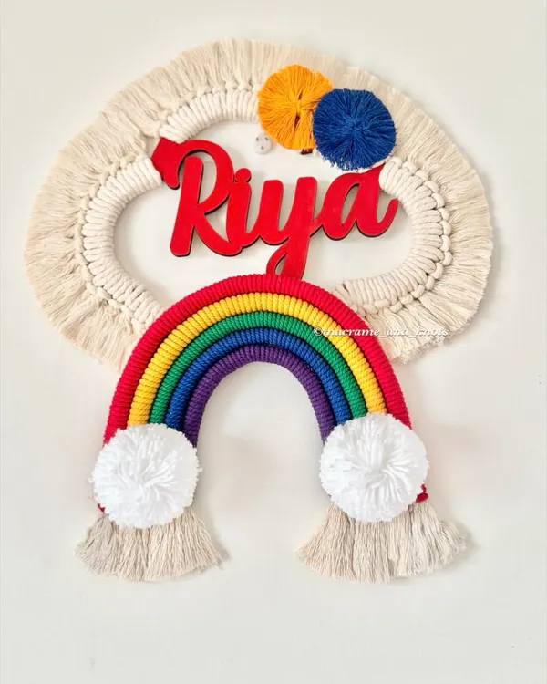 A bright and cheerful rainbow name hanging for Riya. The classic rainbow colors, fluffy pom-pom clouds, and bold red name make this a perfect piece of decor for a child's room.