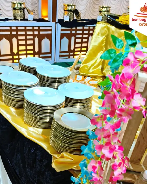 For a beautiful wedding at Narayan Gardens, we set up this stunning buffet. The decor featured gold and black linens with floral accents, complemented by our premium gold-rimmed plates, creating a luxurious dining atmosphere.