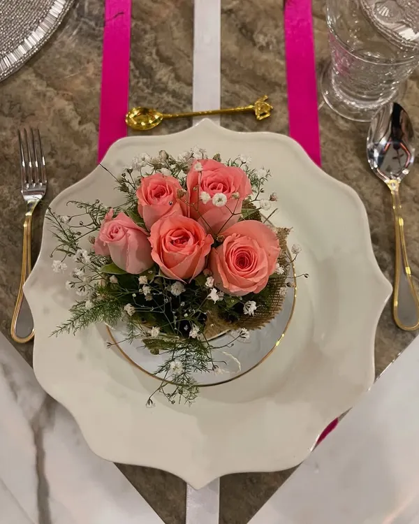 This elegant pink ribbon-themed tablescape is a perfect example of how I create a special mood for any occasion. The delicate floral centerpiece on the scalloped plate, paired with gold and silver cutlery, sets a tone of grace and celebration.