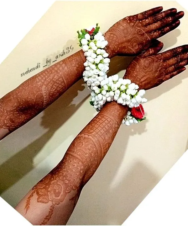 The stunning result of my organic henna paste after 48 hours. The deep, dark stain looks beautiful against the skin and is complemented by traditional floral bracelets (gajra).