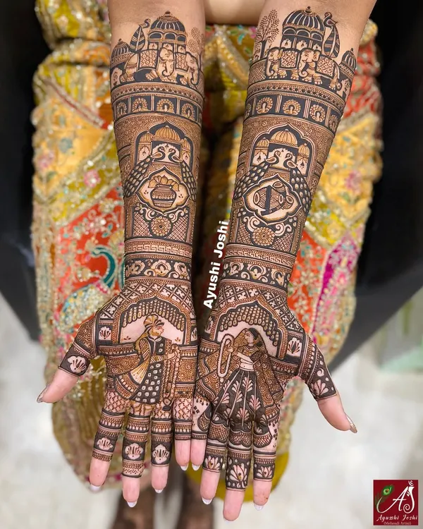 A classic bridal mehendi featuring the Varmala ceremony on the palms. The arms are adorned with royal elephants, peacocks, and auspicious symbols like the dhol, shehnai, and kalash.