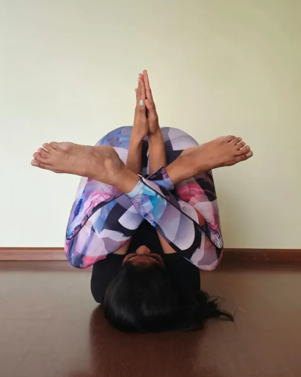 This is a challenging variation of Halasana (plow pose) that provides a deep stretch for the entire spine and shoulders. Remember, consistency and discipline are what lead to progress in your flexibility journey, not just motivation.