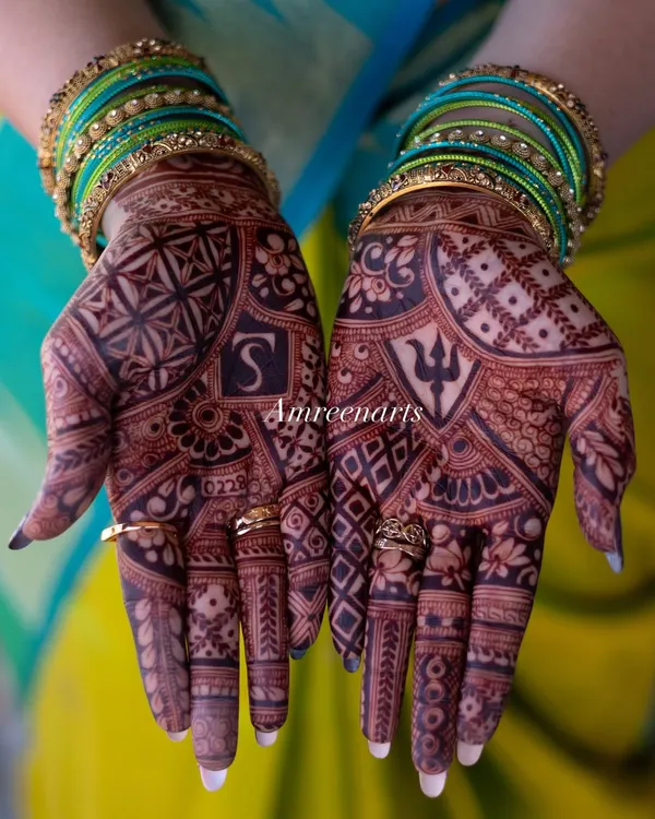 This is the result of my natural henna paste. A deep, rich maroon stain that looks stunning against the bride's colorful bangles.