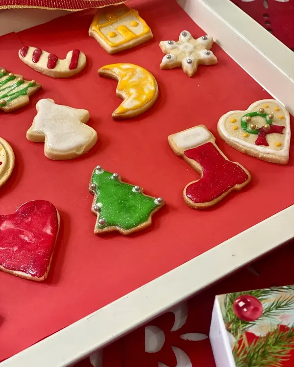 Our Christmas cookie collection is all about festive cheer! This tray features a variety of our hand-decorated holiday cookies, including Christmas trees with silver dragées, classic stockings, shiny candy canes, and delicate snowflakes.