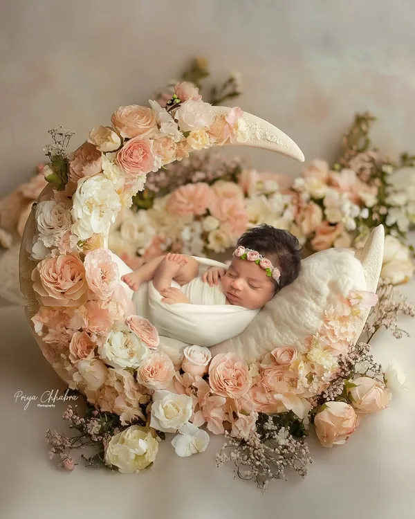 Cradled by the moon and surrounded by blossoms, this is where dreams begin. I love creating these fairytale setups to capture the pure magic of your newborn's first days.