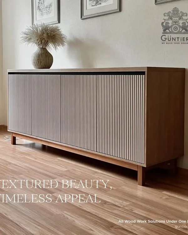 A timeless sideboard cabinet featuring a light-colored fluted veneer. This piece combines minimalist design with textured beauty, making it a functional work of art.