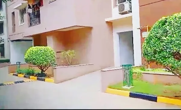 This is an example of our maintenance work for an apartment building. We keep the shrubs neatly trimmed and the lawn healthy, enhancing the building's curb appeal for all residents.