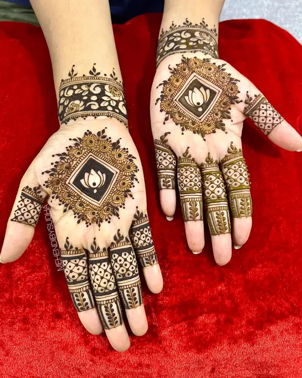 A striking and modern mandala design. The central lotus is placed inside a black-filled diamond, creating a bold contrast. The finger details are geometric and clean, completing the contemporary look.