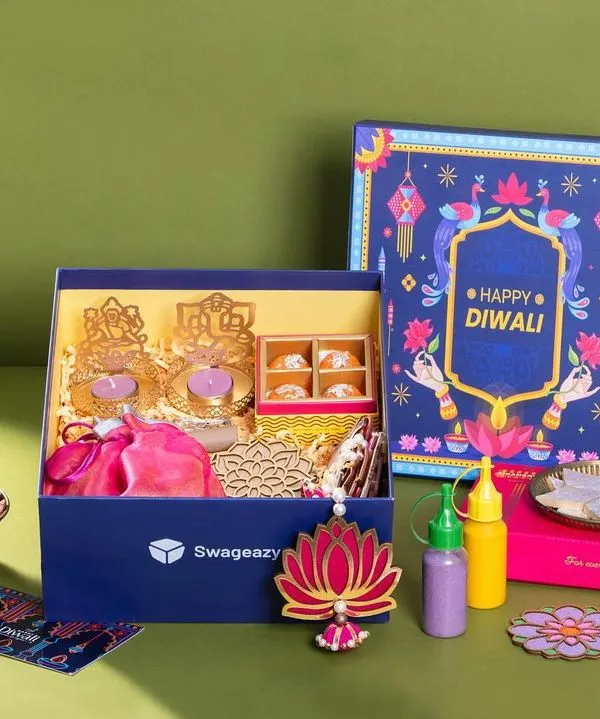 A festive hamper shoot for Swageasy, capturing a colorful Diwali gift box. The flat lay composition is carefully arranged to display all the contents, from sweets and nuts to decor items, making it ideal for seasonal marketing campaigns.
