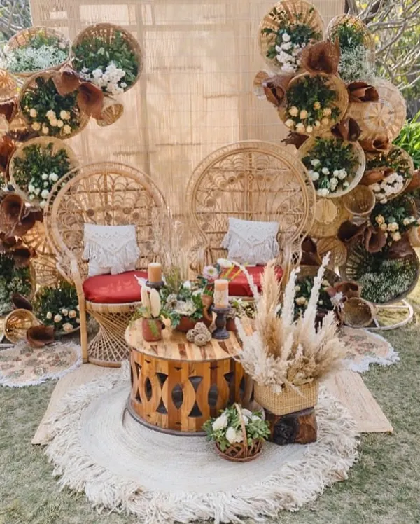 A perfect balance of wild and warm for a Mehendi. This seating features peacock-style cane chairs against a backdrop of woven baskets, pampas, and macrame, creating a free-spirited and inviting space.