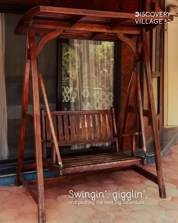 A wooden swing on the porch, perfect for quiet moments of reflection or planning your next big adventure.