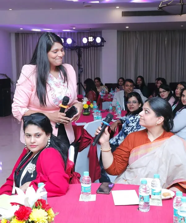 Moving through the audience at the AccelHERate conference. I make it a point to interact directly with attendees, ensuring their questions are heard and making the session more dynamic.