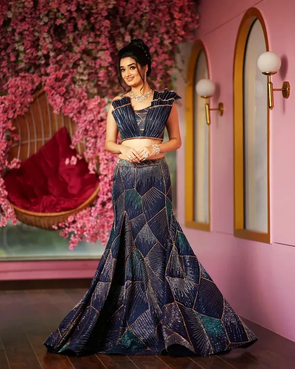 This is one of my favorite creations, a new-age contemporary lehenga. I designed this piece with a sculpted skirt featuring geometric patterns and a 3D hand-embroidered corded cut dana blouse with architectural shoulders, perfect for a client who wants a truly standout reception outfit.