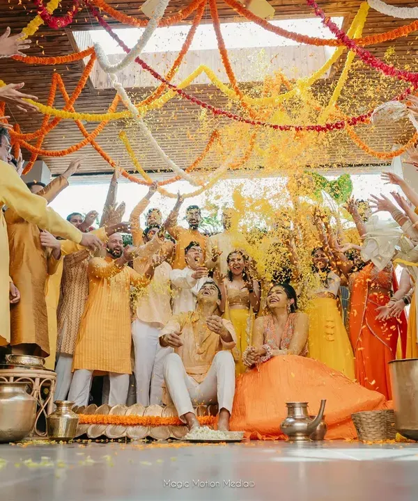 A spectacular moment of joy at a Haldi ceremony, where family and friends shower the couple in a sea of yellow petals. We created a vibrant floral backdrop to make the celebration even more colorful.