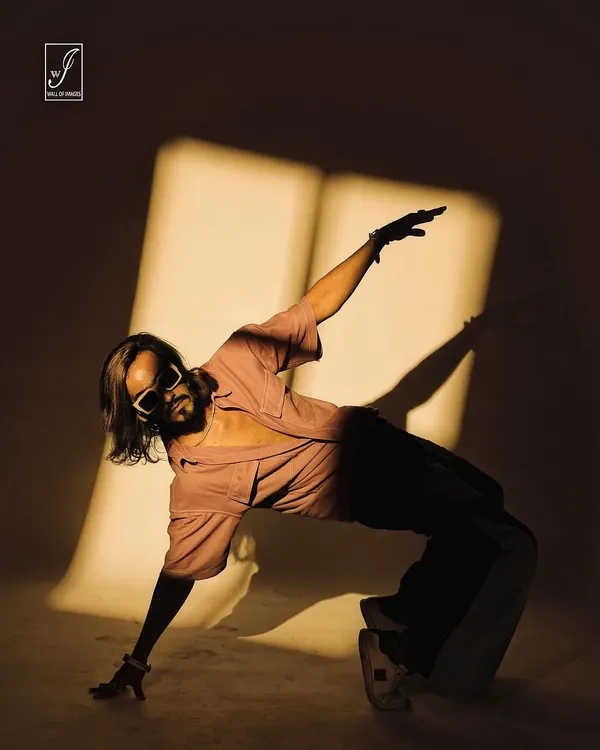 A dynamic shot from our shadow-play series. The model's pose interacts with the projected light, creating a fusion of dance, form, and shadow.