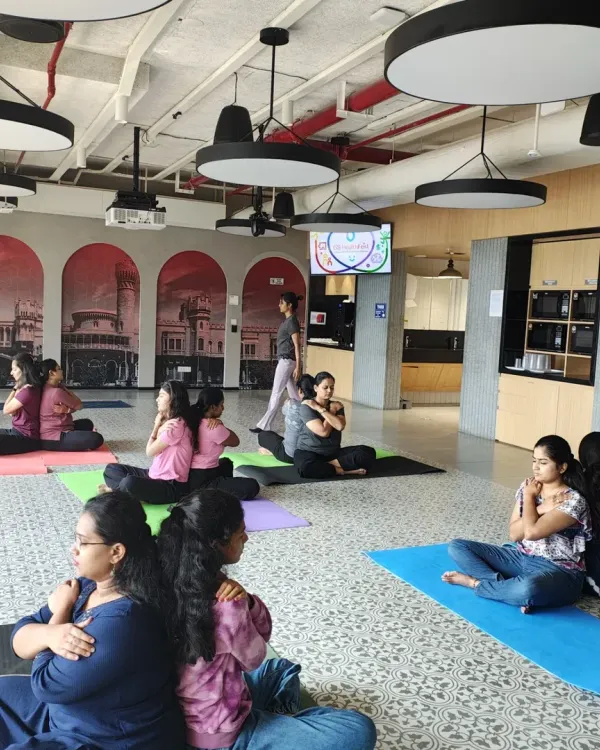 Partner yoga is a fantastic tool for building trust and communication. Here, employees at Johnson & Johnson support each other in a gentle back-to-back twist.
