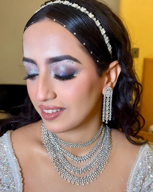 For this showstopper sangeet look, we went all out with dramatic, glittery eyes and rhinestones. The makeup is grand, glamorous, and designed to make a statement.