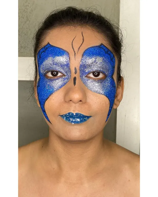 I created this bold, high-fashion butterfly look with vibrant blue and silver glitter, perfect for an editorial shoot or a model's portfolio that needs to stand out.