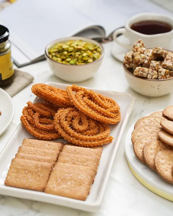 My ideal coffee time platter includes a little bit of everything. Here you can see my spiral butter murukku and savory mathri, ready to be enjoyed with a hot beverage.