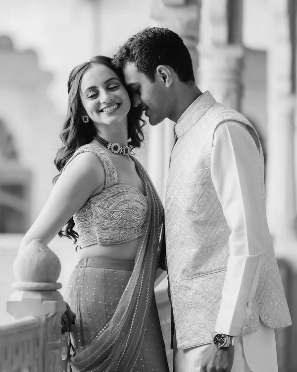 A classic black and white portrait of Saloni and Kanav from their palace shoot. The soft lighting and their gentle expressions create a feeling of timeless romance.