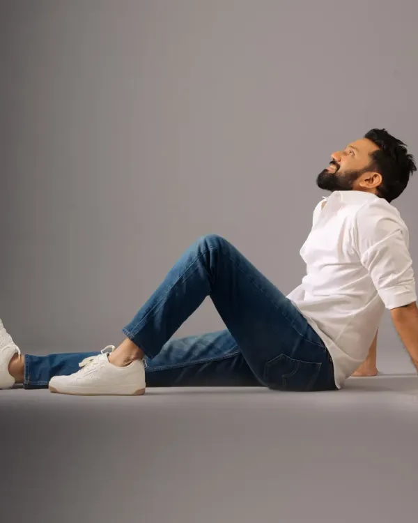 A relaxed and happy shot of actor Ankith Madhav. For this studio session, I focused on clean grooming, ensuring his skin looked even and natural under the lights while keeping his hair and beard perfectly styled.