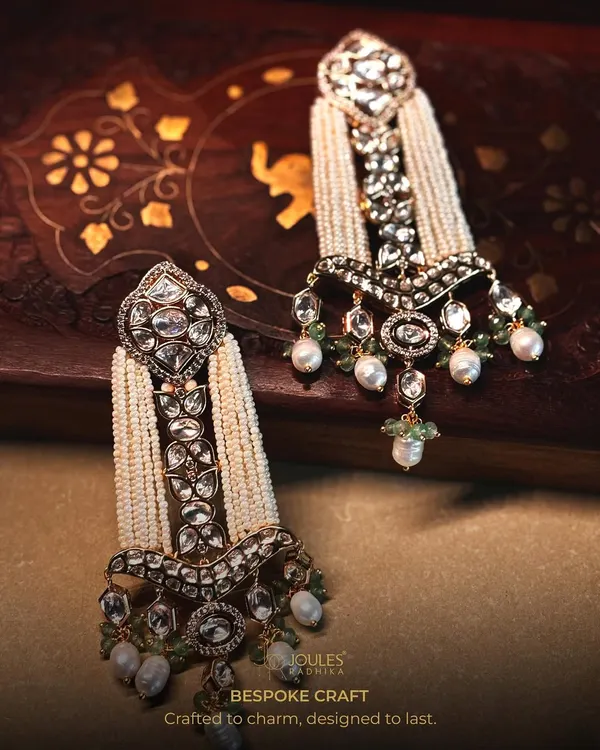 Bespoke craft designed to be remembered. These magnificent earrings feature cascades of pearls and intricate polki work, a true statement of bridal luxury.