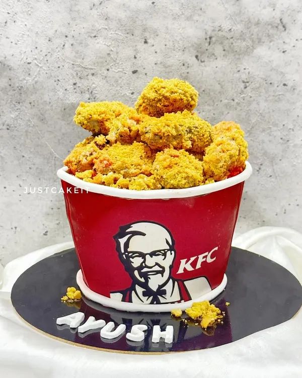 It's finger-lickin' good, and it's also a cake! This is my fully edible KFC bucket cake, made for a huge fan. The "chicken" is made from cake and a crunchy coating, and the bucket is also part of the cake.