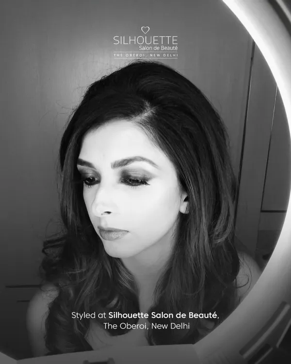 A black and white portrait of author Aishwarya Jha, styled by our team. The dramatic eye makeup and soft hair create a moody and artistic feel, captured beautifully under a ring light.