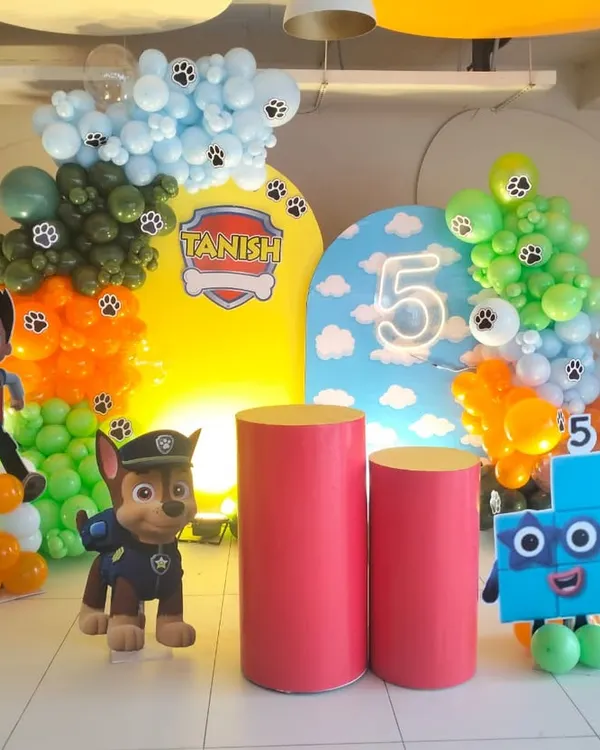 Here is another angle of the Paw Patrol birthday setup, showing the full arrangement with character props and personalized backdrops.