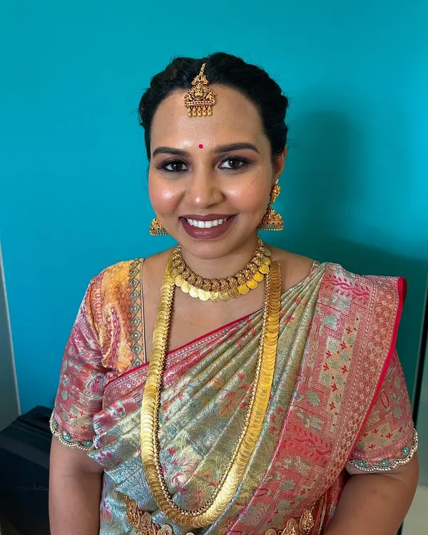 A closer look at the makeup for this traditional naming ceremony. I used warm, earthy tones on the eyes and a complementary lip color to harmonize with the client's classic gold temple jewellery.