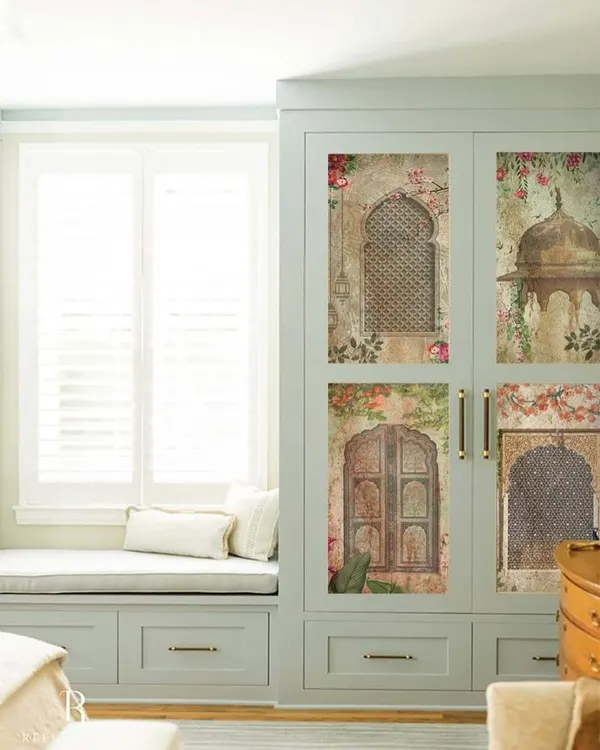 This wardrobe becomes a portal to another era with custom panels depicting scenes from Indian palaces. The artwork, featuring traditional jharokhas and archways, turns storage into a piece of heritage art, blending seamlessly with the room's classic aesthetic.