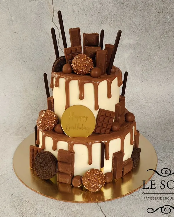 A chocolate lover's dream. This 1.5 kg two-tier Milk Chocolate Truffle cake is loaded with various chocolates like Ferrero Rocher, KitKat, and Oreos, and finished with a chocolate drip.