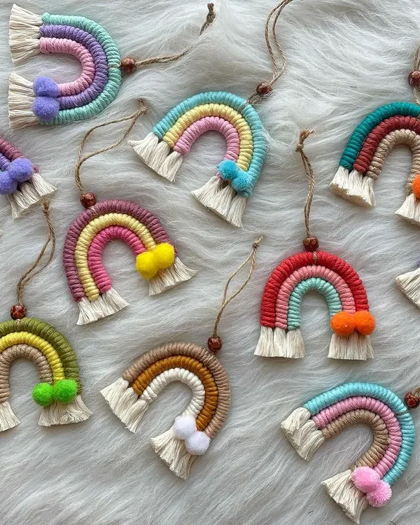 A cheerful collection of my mini macrame rainbow charms. These versatile pieces can be used as car dashboard ornaments, bag charms, or even small wall hangings. Each one is made with colorful cords and features a tiny pom-pom accent.